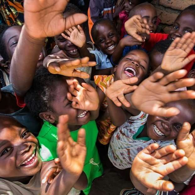 Joyful children reaching out their hands