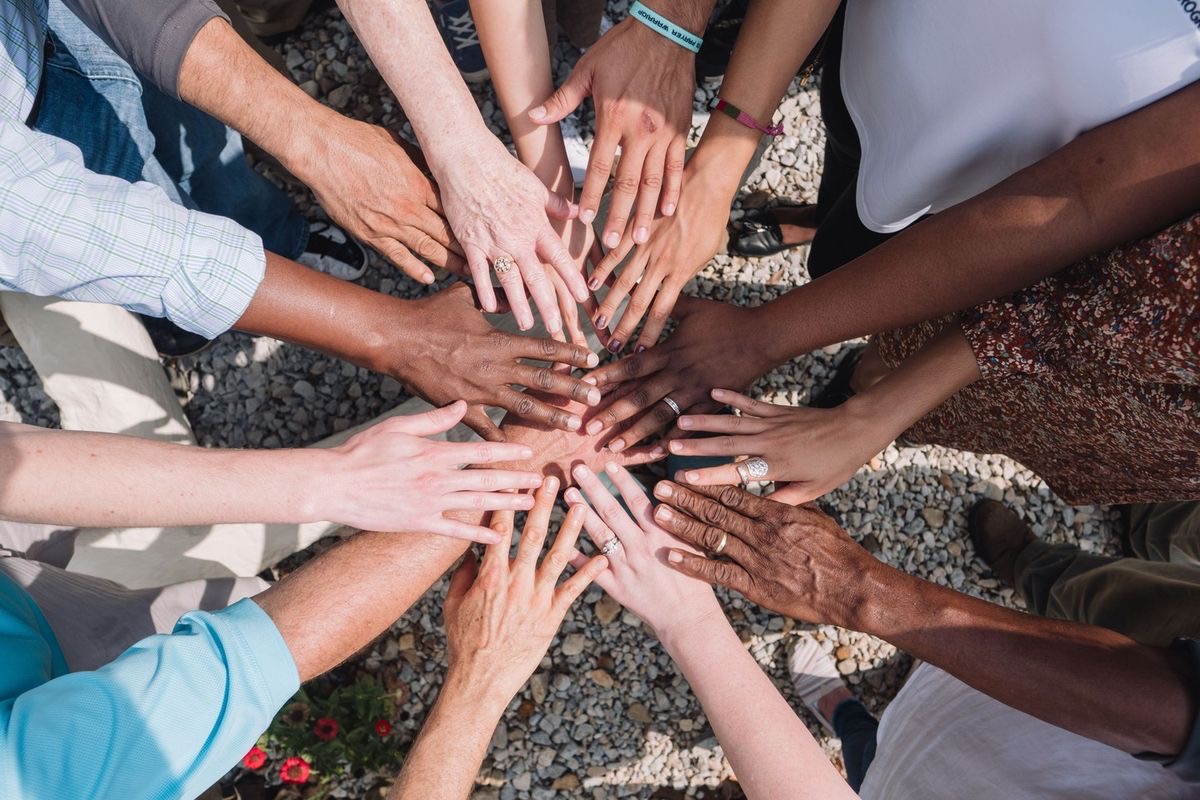 Many hands united in the center